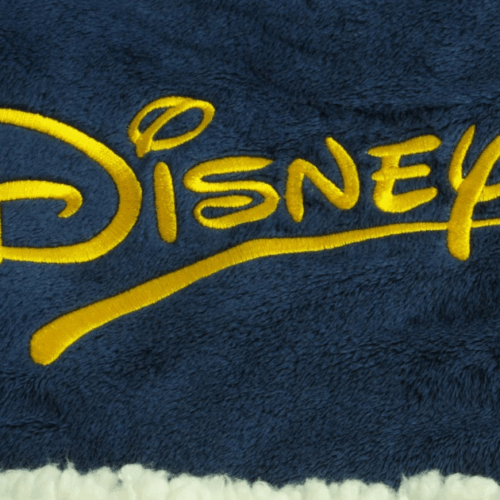 Custom Disney logo embroidered on navy fleece blanket with cream sherpa lining
