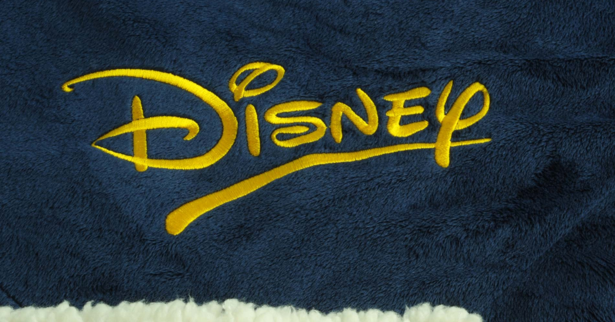 Custom Disney logo embroidered on navy fleece blanket with cream sherpa lining
